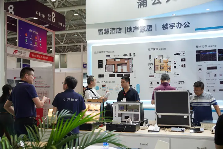 Staff and visitors talk beside smart space solution displays and demonstration cases
